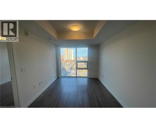 A spacious room with a view of the city through a large window.