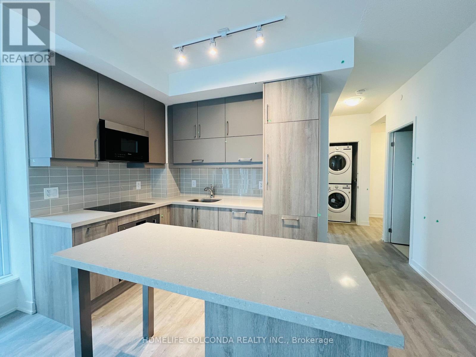 A modern kitchen with a large island in the middle.