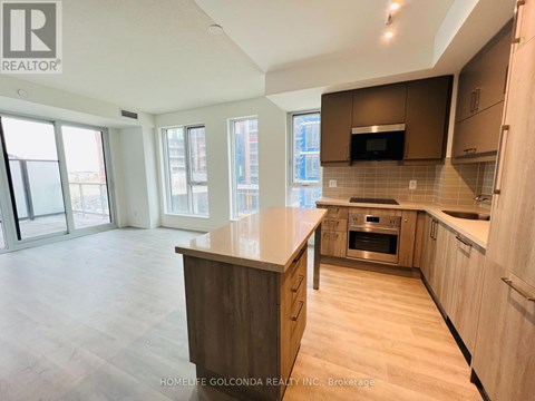 A kitchen with wooden cabinets and a countertop is shown.