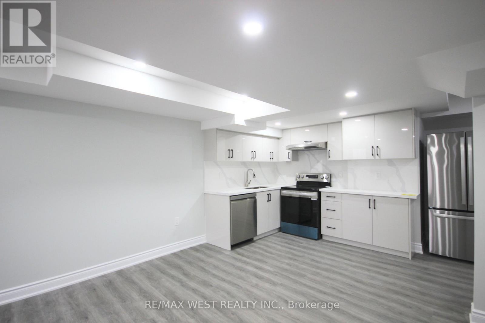 A kitchen with white cabinets and stainless steel appliances.