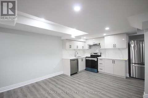 A kitchen with white cabinets and stainless steel appliances.