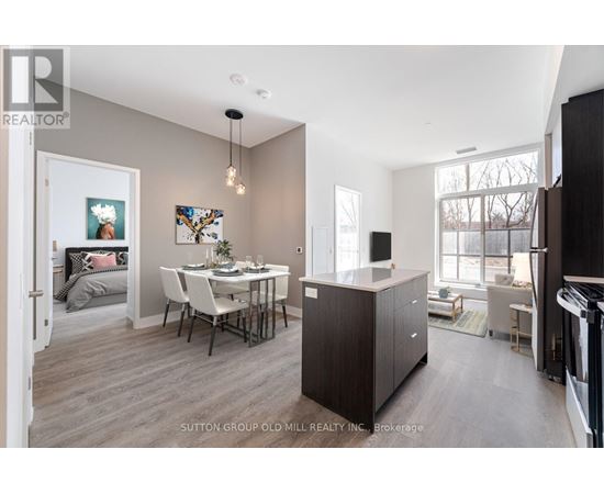 A modern kitchen with a dining table and chairs.