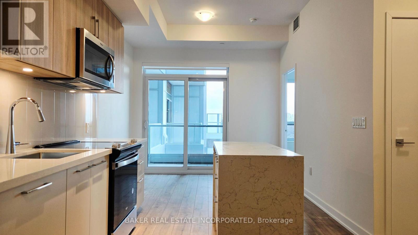 A kitchen with a microwave and oven above the counter.