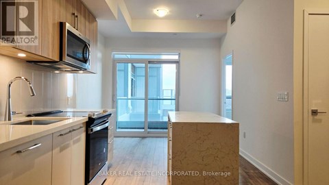 A kitchen with a microwave and oven above the counter.