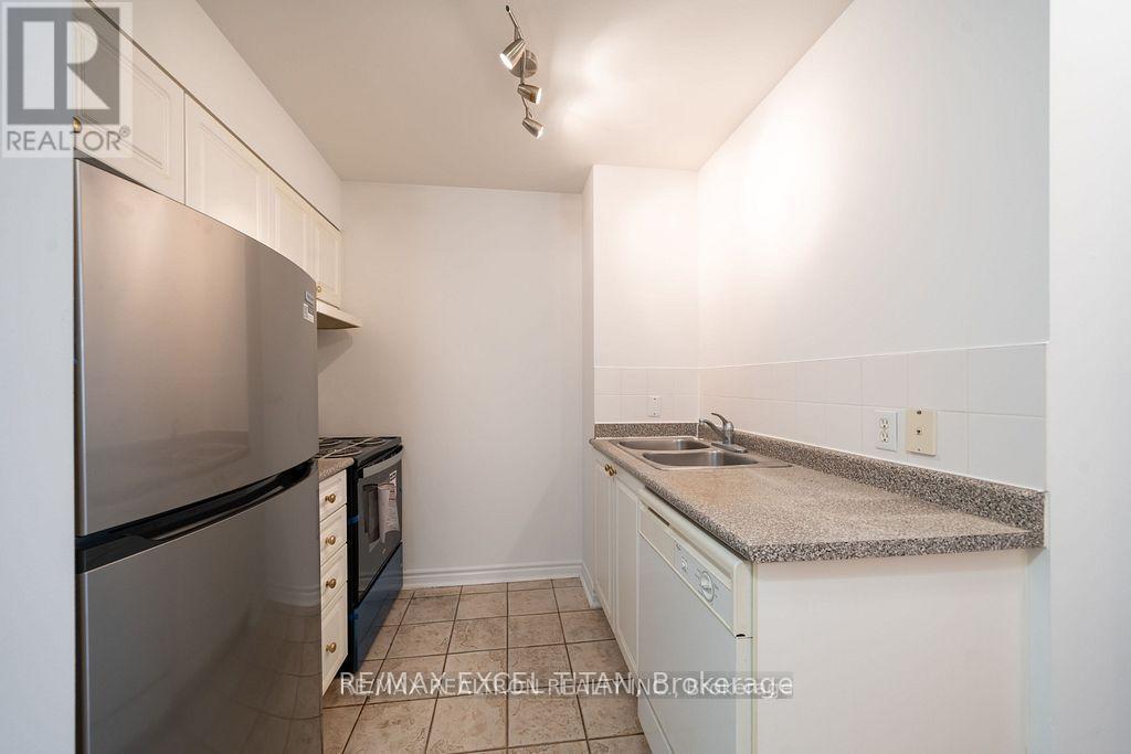A kitchen with white cabinets and a granite countertop.