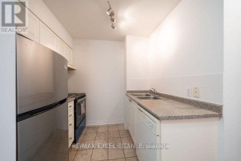 A kitchen with white cabinets and a granite countertop.