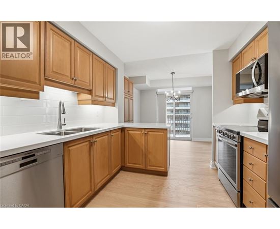 A kitchen with wooden cabinets and stainless steel appliances.