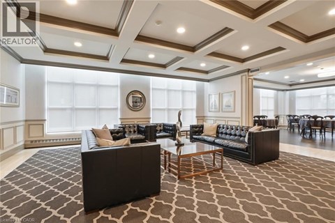 A living room with a black couch and a wooden coffee table.