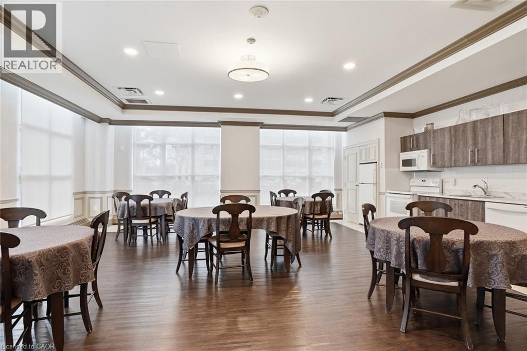 A dining room with wooden floors and tables set with placemats.