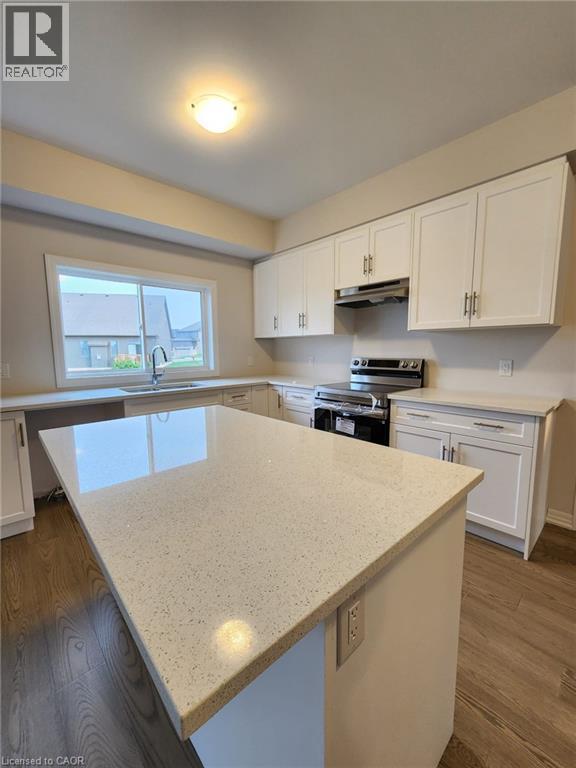 A kitchen with white cabinets and a large island.