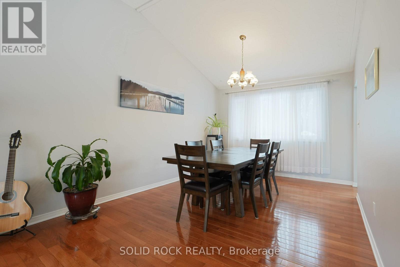 A dining room with a wooden table and chairs.