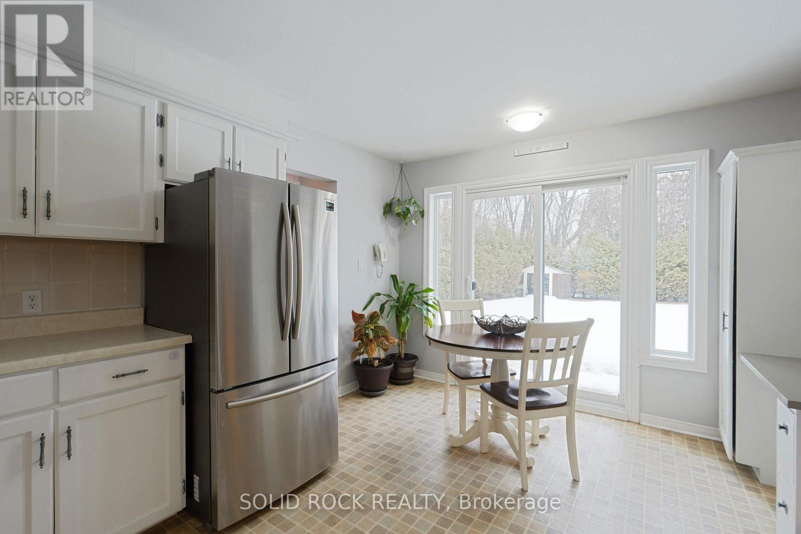 A kitchen with a table and chairs in the middle of the room.