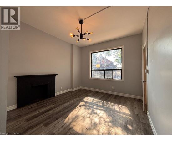 A room with a fireplace and a window.