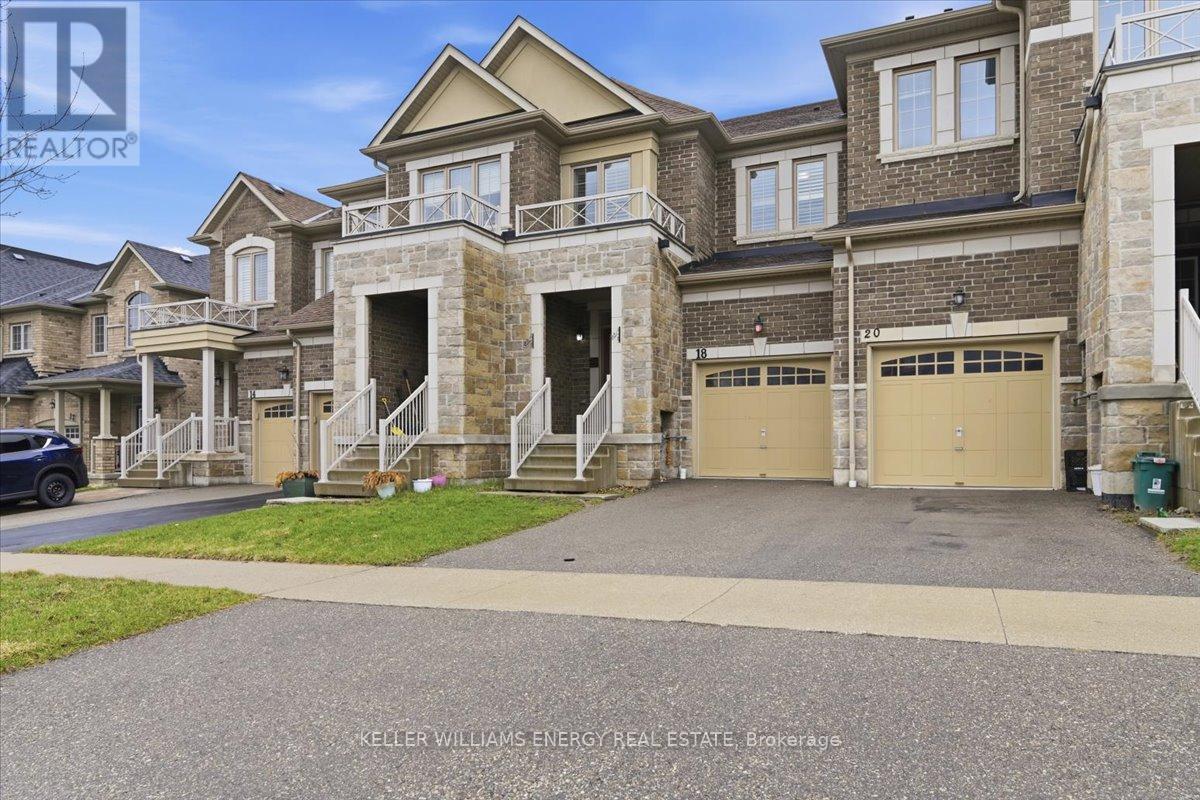 A large, multi-level house with a driveway in front.