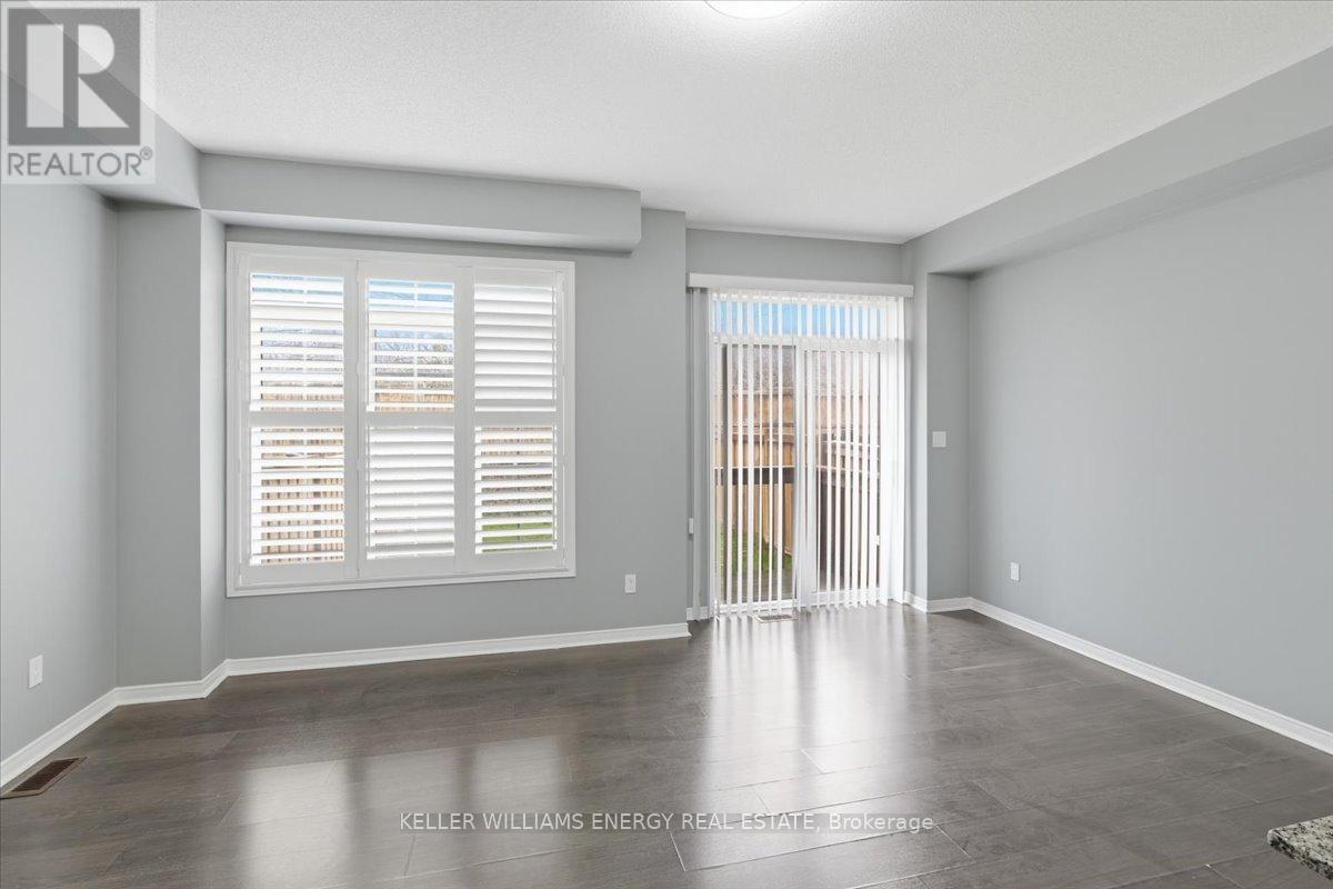 A spacious room with a sliding glass door leading to a balcony.