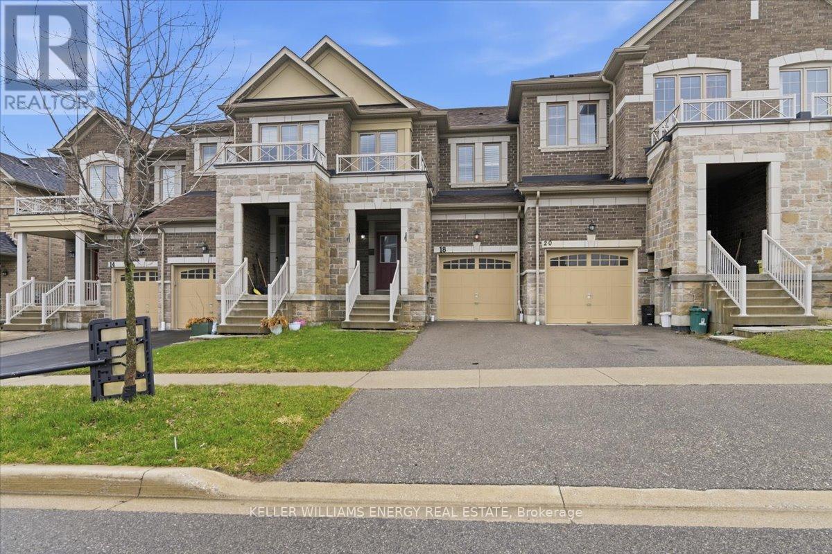 A large, multi-level house with a driveway in front.