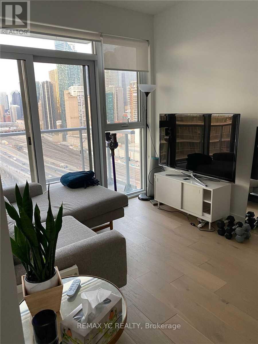 A living room with a large window overlooking a cityscape.