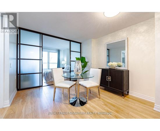 A dining room with a glass table and chairs.