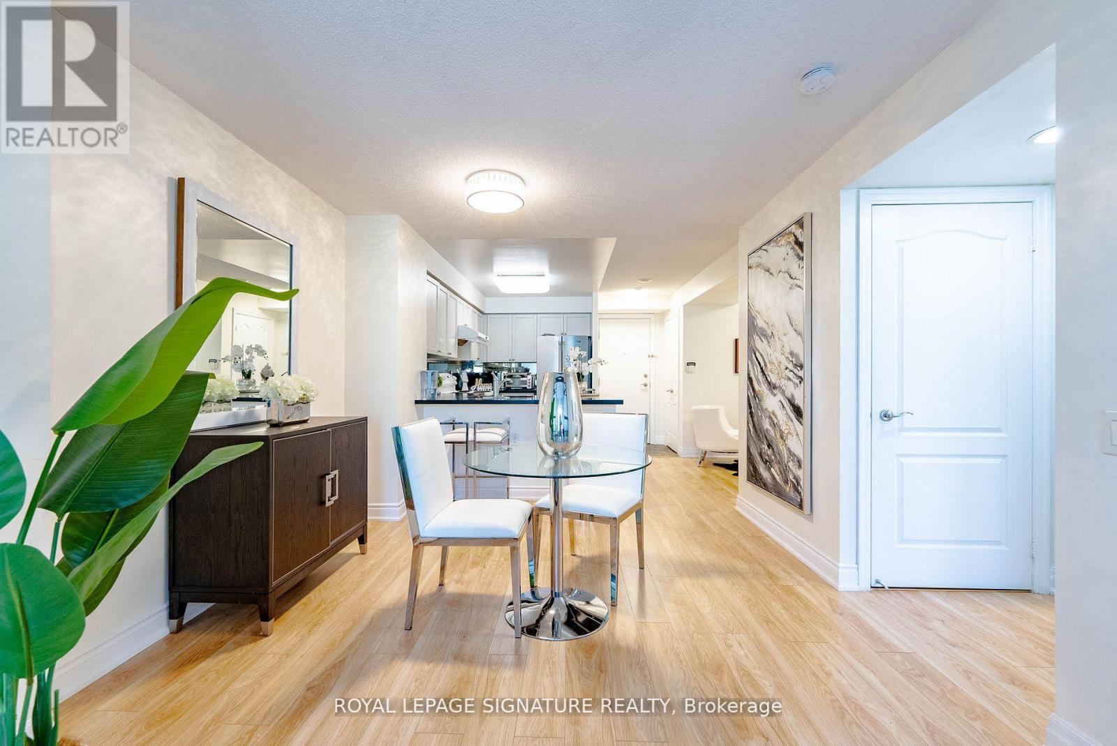 A well-lit, spacious room with a dining table and chairs.