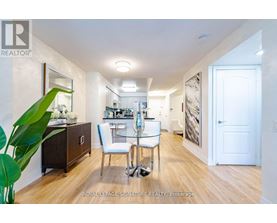 A well-lit, spacious room with a dining table and chairs.