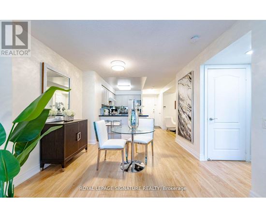 A well-lit, spacious room with a dining table and chairs.