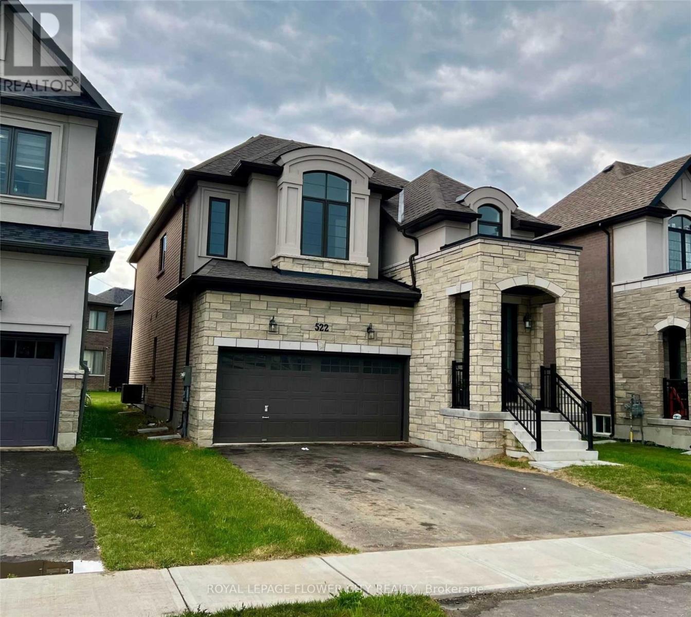 A house with a garage and a driveway in front.