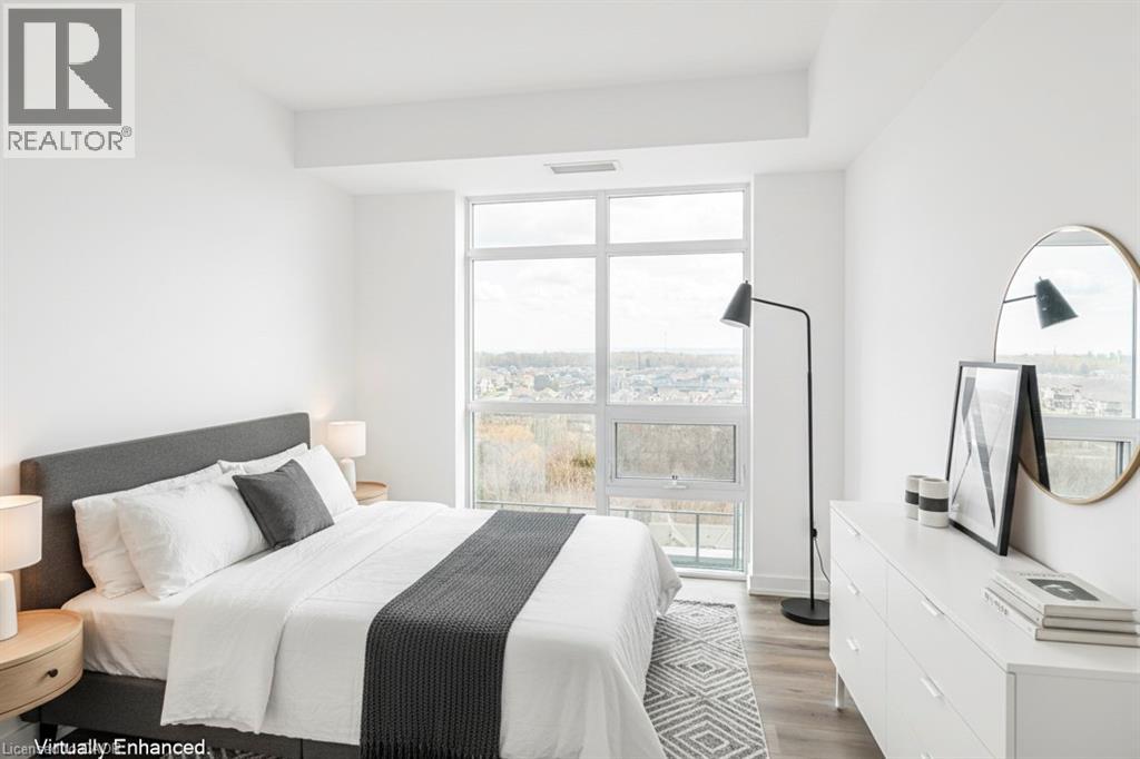 A bedroom with a large bed and a view of the city.