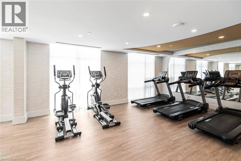 A gym with treadmills, elliptical machines and other exercise equipment.