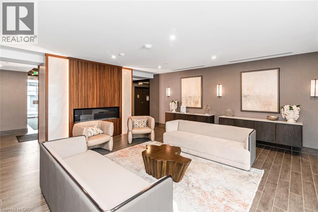 A living room with a white couch and a fireplace.