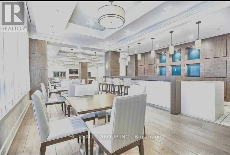 A dining room with a long table and chairs.