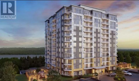 A modern apartment building with a parking lot in front.