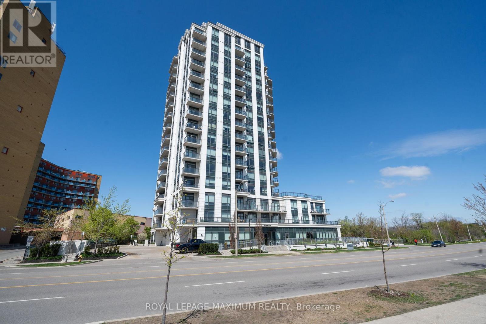 A tall building with many windows is the main focus of the image.