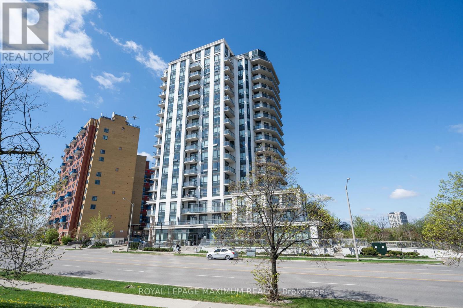 A tall building with many windows is in the foreground of the image.