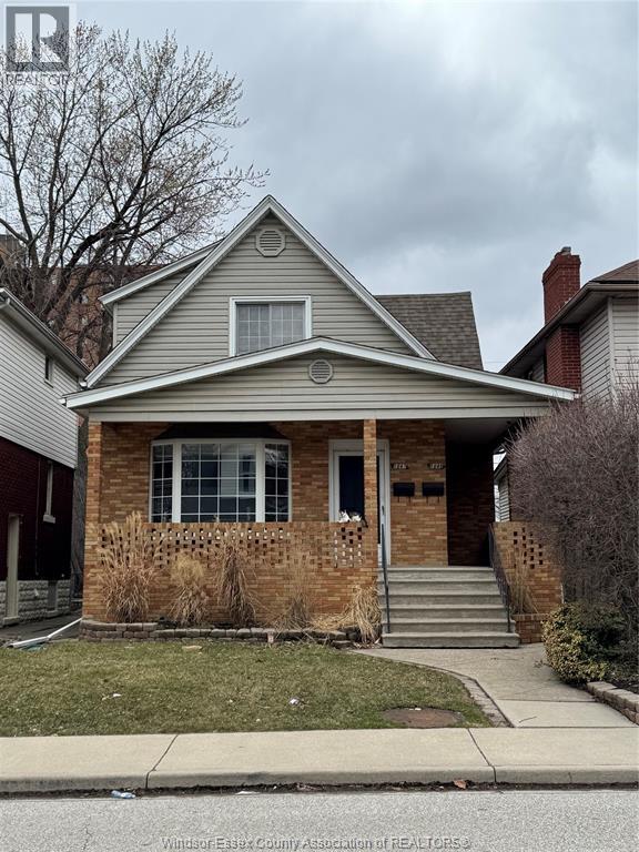 A house with a grey roof and a brick wall.