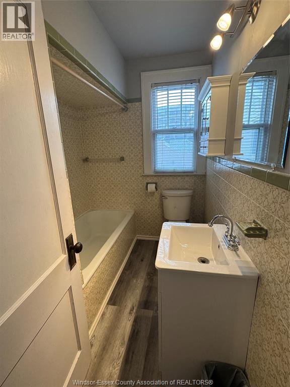 A bathroom with a sink, toilet, and bathtub.