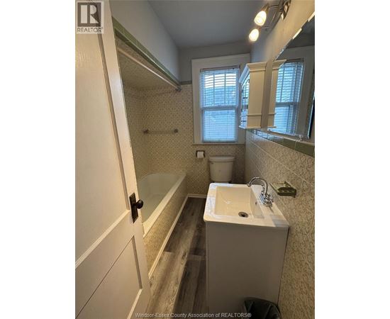 A bathroom with a sink, toilet, and bathtub.