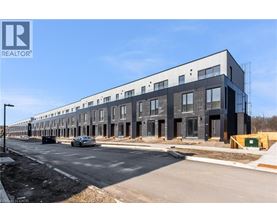 A modern building under construction with a REALTOR® logo.