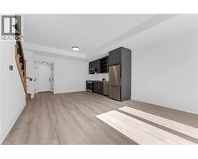 A kitchen area with a refrigerator, oven, and microwave.