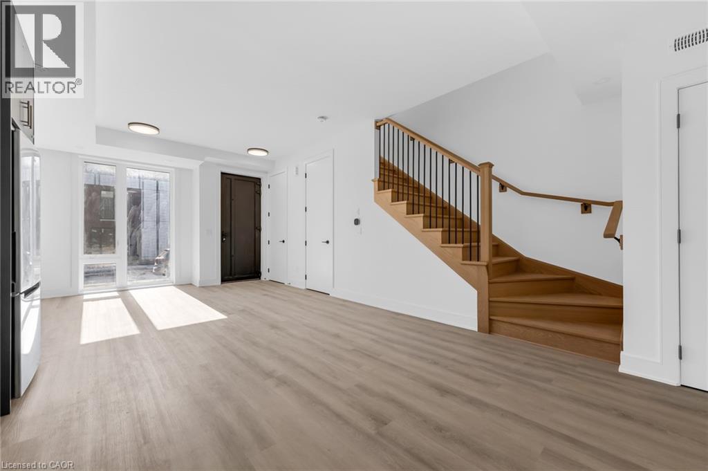 A spacious room with a staircase leading to the upper floor.