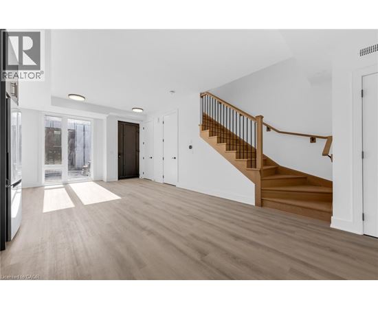 A spacious room with a staircase leading to the upper floor.