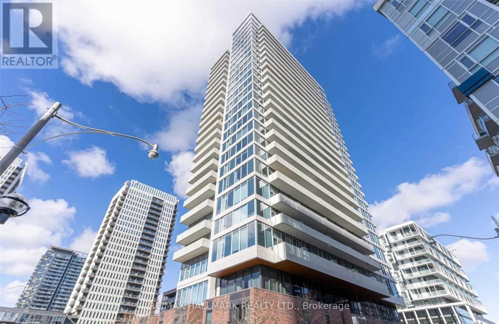 A tall building with many windows is the main focus of the image.