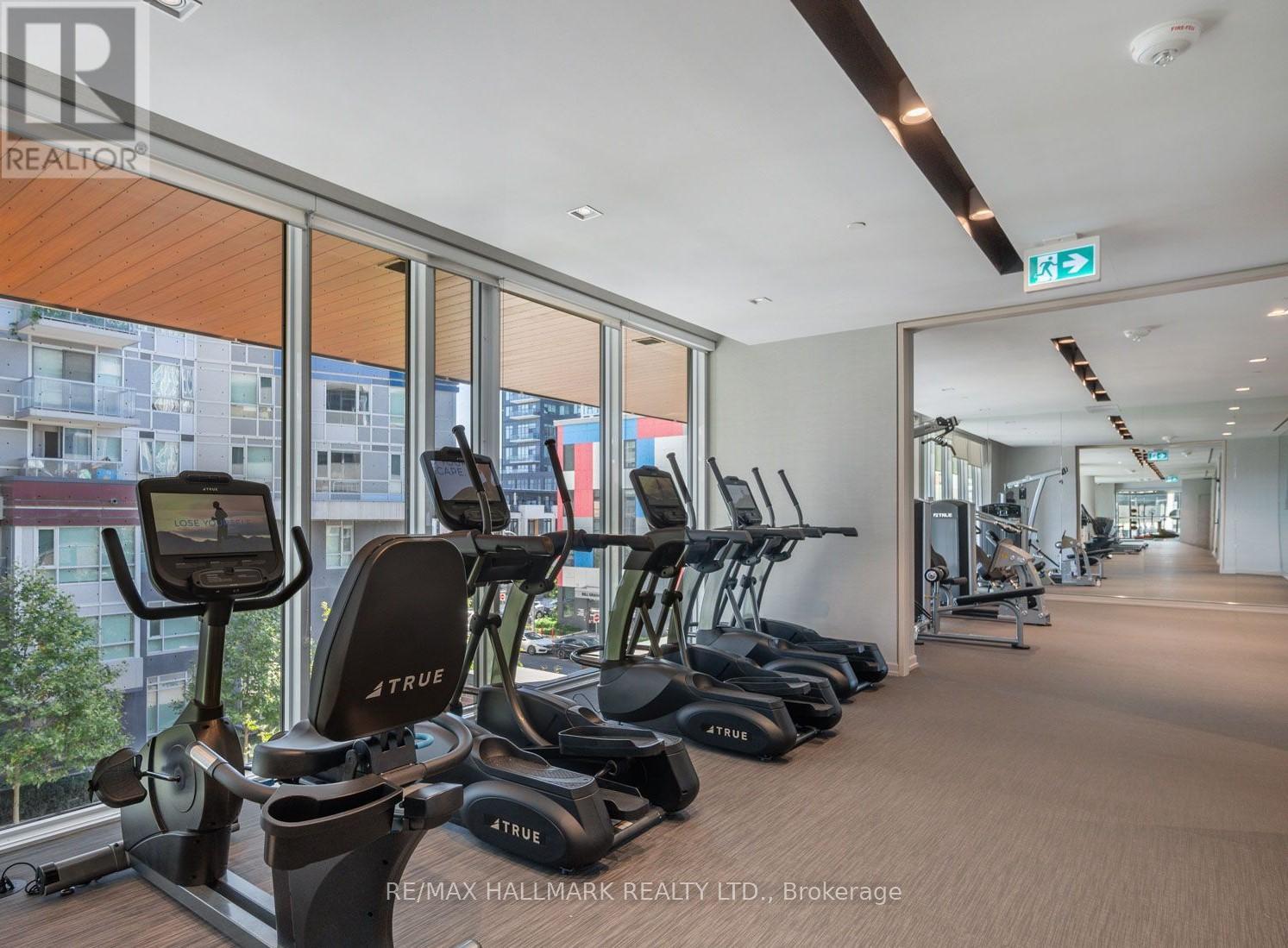 A gym with treadmills and exercise bikes is shown.