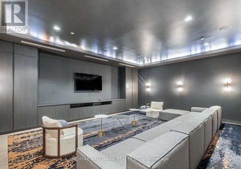 A modern living room with a grey sofa and a television.