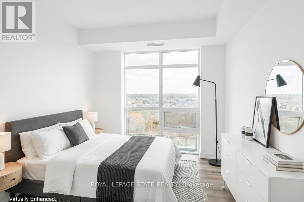 A bedroom with a large bed and a view of the city.