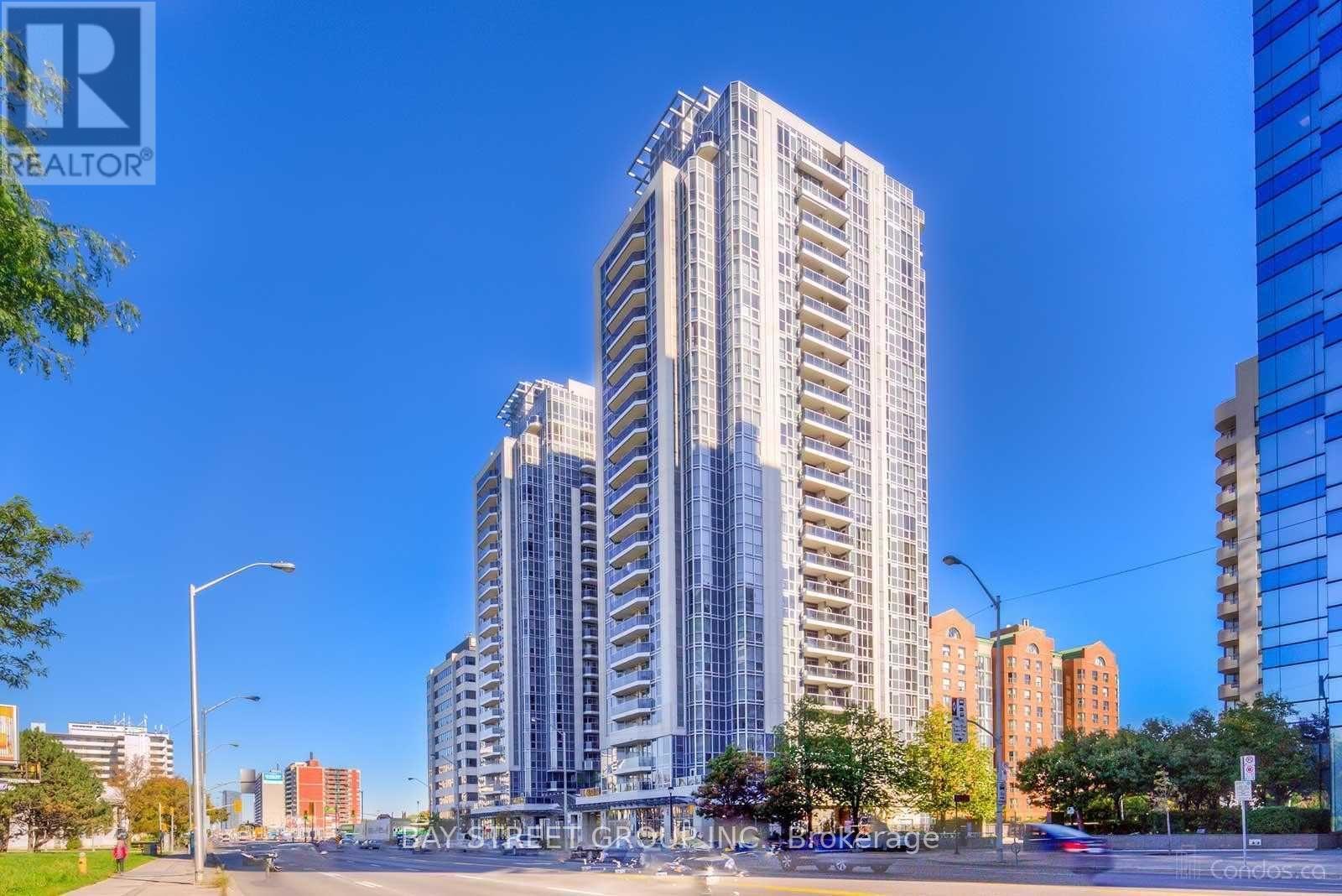 A tall building with many windows is in the foreground of the image.