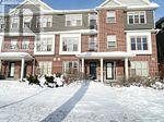 A large brick building with a snow covered walkway in front.
