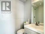 A white bathroom with a sink and mirror.