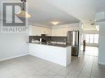A realtor sign is on the wall of a kitchen.