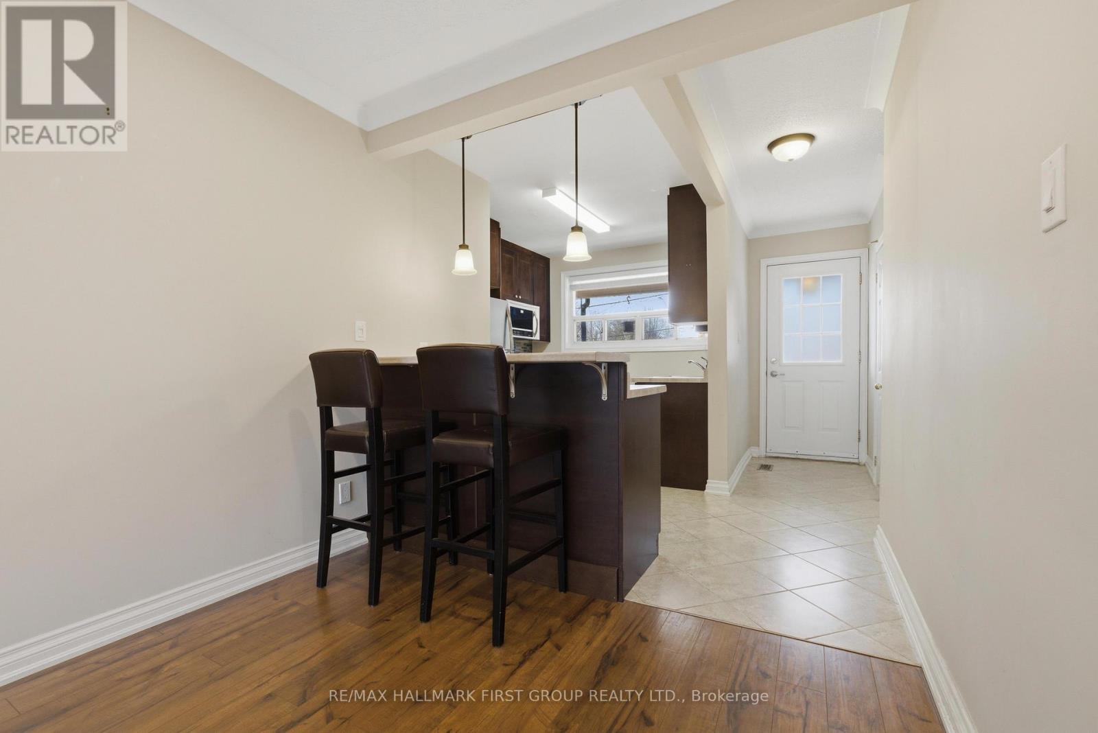 A dining room with a wooden table and chairs.