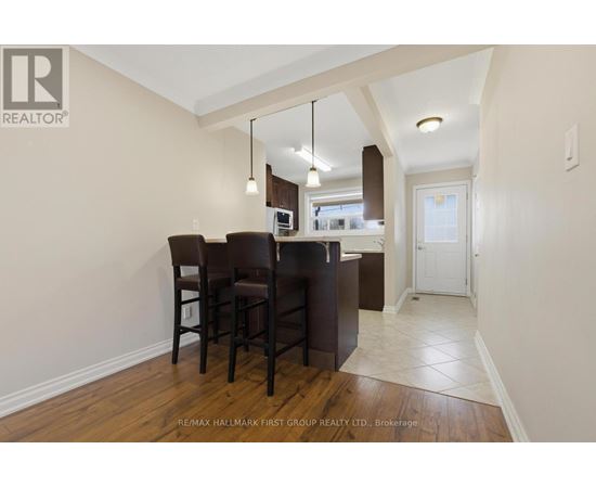 A dining room with a wooden table and chairs.